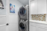 Discover this beautifully appointed laundry room featuring a stacked washer and dryer for space efficiency.
