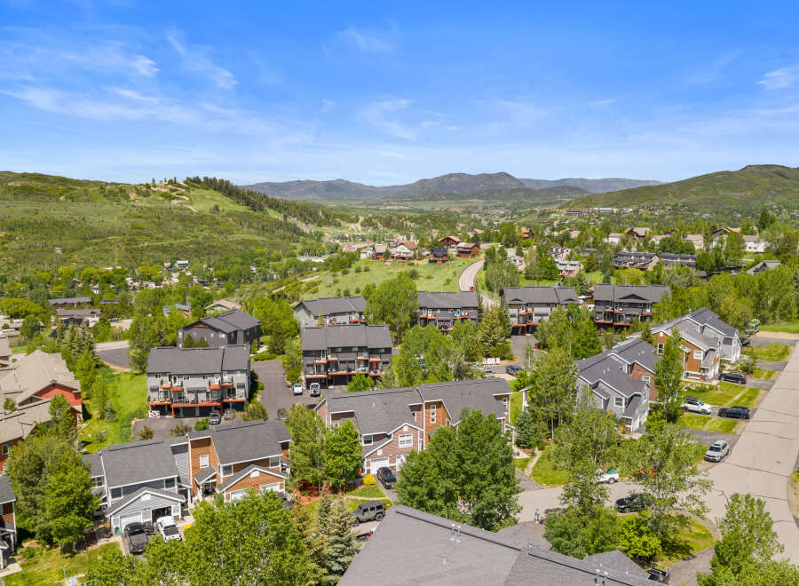 Discover this stunning mountain community featuring modern townhomes nestled amidst lush greenery and scenic vistas.