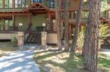 Discover this charming mountain home featuring a welcoming covered porch with comfortable seating, perfect for enjoying the serene surroundings.