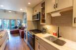 This charming studio apartment offers a compact yet functional kitchen area, complete with a microwave, gas range, and a coffee maker.