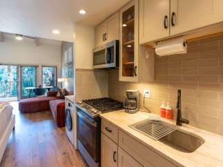 This charming studio apartment offers a compact yet functional kitchen area, complete with a microwave, gas range, and a coffee maker.