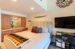 Experience ultimate comfort in this beautifully appointed bedroom, featuring a plush king-sized bed adorned with a cozy bear-themed blanket.