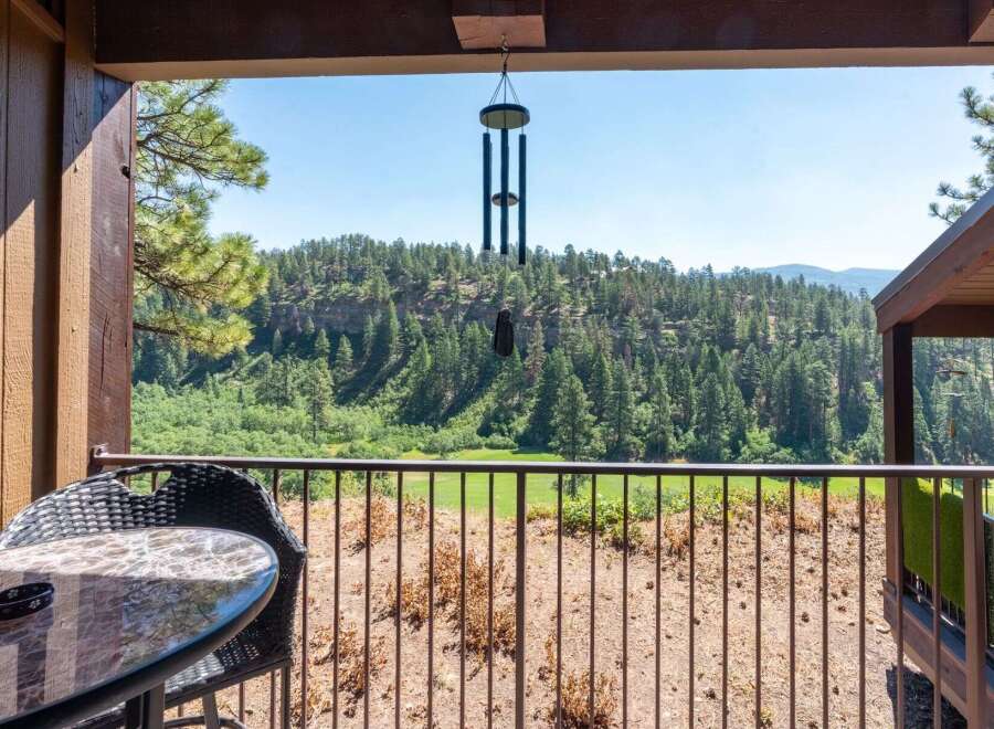 Enjoy breathtaking mountain views from this charming balcony, complete with a table and chairs for morning coffee or evening relaxation.