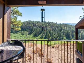 Enjoy breathtaking mountain views from this charming balcony, complete with a table and chairs for morning coffee or evening relaxation.