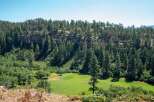 Discover this stunning property nestled amidst a lush forest with a picturesque golf course.