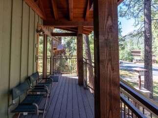 Enjoy the serene mountain setting from this charming porch, perfect for morning coffee or evening relaxation.