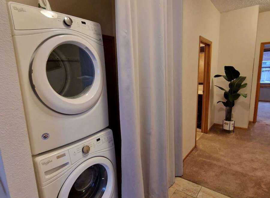 Discover convenience with this stacked Whirlpool washer and dryer set, perfect for maximizing space in your laundry area.