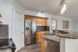 This modern kitchen boasts stainless steel appliances, including a French door refrigerator and a built-in dishwasher.