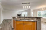 Experience modern living in this beautifully updated kitchen, featuring a granite-topped island with a double sink and ample cabinet space.