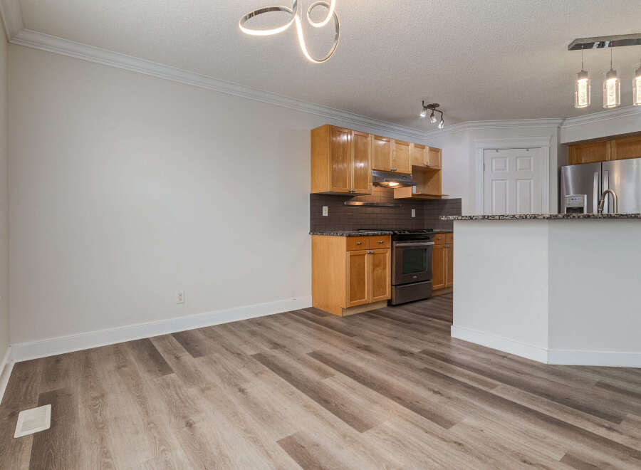 Discover this beautifully updated kitchen featuring sleek wooden cabinetry and modern stainless steel appliances.