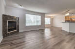Experience modern living in this spacious open-concept home, featuring a striking granite fireplace as a focal point.