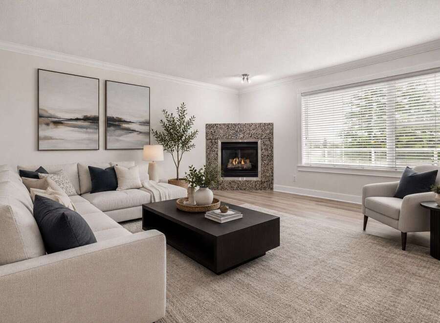 Experience modern living in this beautifully appointed living room, featuring a striking stone-clad fireplace as the centerpiece.