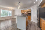 Discover this stunning kitchen and dining area, featuring elegant granite countertops and warm wooden cabinetry.