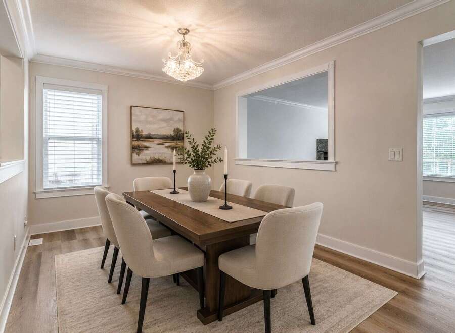 Experience elegant dining in this beautifully appointed space, featuring a spacious wooden table and comfortable upholstered chairs perfect for hosting.