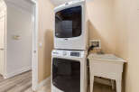 This laundry room features a stacked Maytag washer and dryer set, perfect for maximizing space.