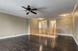 Step into this inviting living space featuring a sleek ceiling fan and rich, dark hardwood floors that gleam under recessed lighting.
