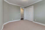 This spacious room features a neutral carpet and light green walls, creating a serene atmosphere.