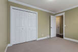 This spacious room features a large double door closet with elegant trim, perfect for ample storage.