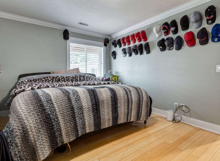 This bedroom features a cozy bed adorned with a striped blanket, perfect for relaxation.
