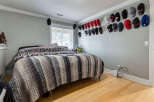 This bedroom features a cozy bed adorned with a striped blanket, perfect for relaxation.
