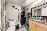 This bathroom features a stacked washer and dryer unit, perfect for maximizing space in a compact area.