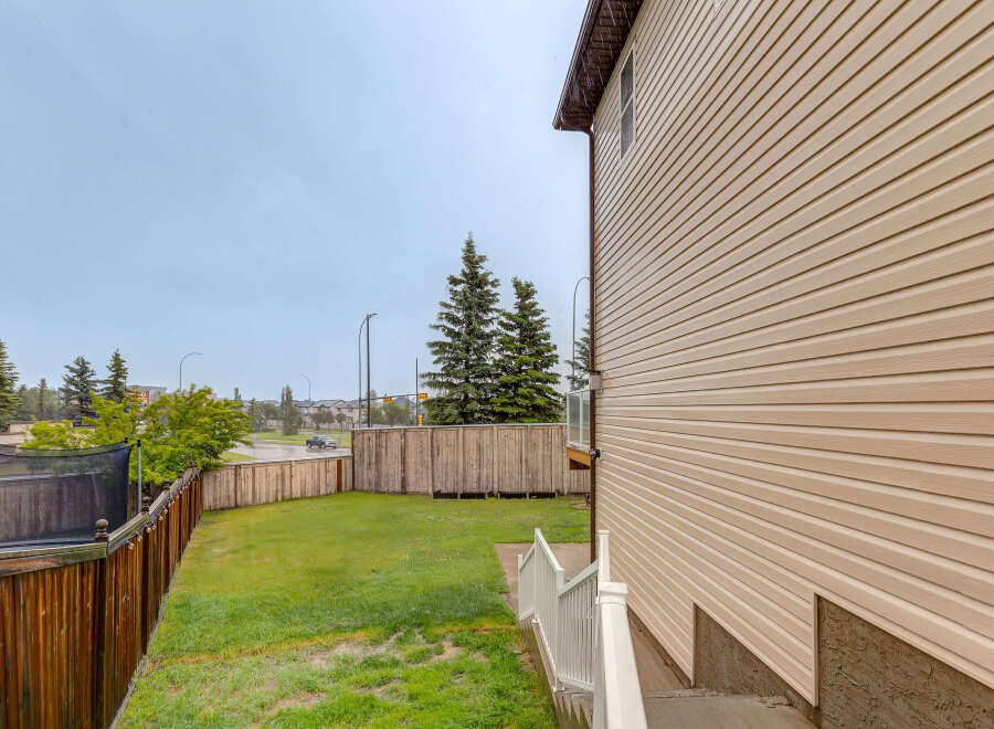 Enjoy outdoor living in this spacious backyard, complete with a trampoline for endless fun.