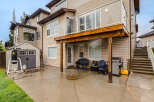 Enjoy outdoor living in this spacious backyard featuring a covered patio perfect for entertaining.