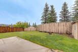 Enjoy outdoor living in this spacious backyard, complete with a fire pit for cozy evenings and a concrete patio perfect for entertaining.