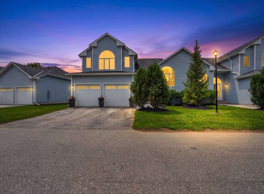 Experience twilight charm in this stunning blue home, featuring a grand arched window and a welcoming double garage.