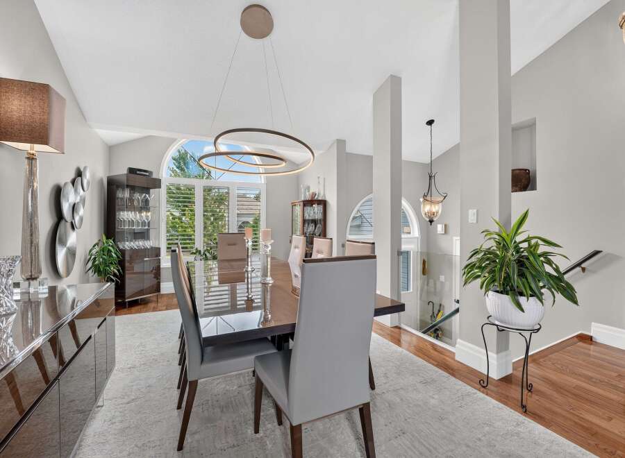 Experience elegant dining in this sophisticated space, featuring a sleek, modern dining set with plush upholstered chairs.