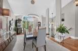 Experience elegant dining in this sophisticated space, featuring a sleek, modern dining set with plush upholstered chairs.