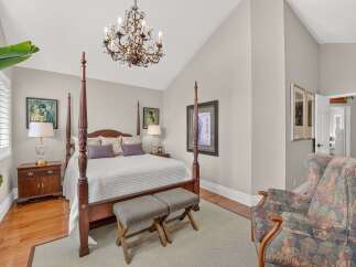 Step into this elegant bedroom featuring a grand four-poster bed as the centerpiece, perfect for restful nights.