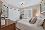 This inviting bedroom features a comfortable queen-size bed with plush bedding and decorative pillows, perfect for relaxation.