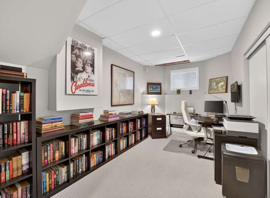 This home office features extensive built-in bookshelves, perfect for organizing your literary collection.