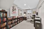 This home office features extensive built-in bookshelves, perfect for organizing your literary collection.