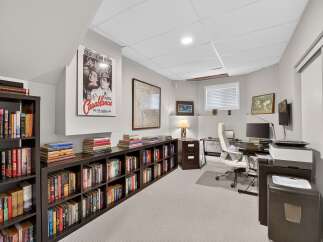 This home office features extensive built-in bookshelves, perfect for organizing your literary collection.