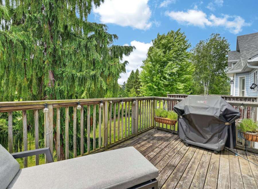 Enjoy outdoor living on this spacious wooden deck, perfect for entertaining or relaxing.