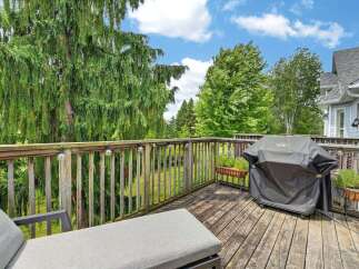 Enjoy outdoor living on this spacious wooden deck, perfect for entertaining or relaxing.
