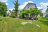 Discover this charming property featuring a well-maintained lawn and lush landscaping, perfect for outdoor enjoyment.