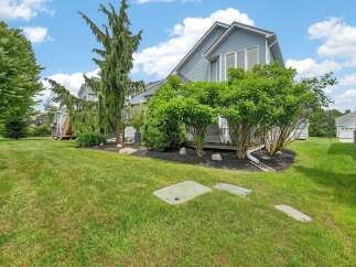 Discover this charming property featuring a well-maintained lawn and lush landscaping, perfect for outdoor enjoyment.