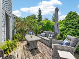 Enjoy outdoor living at its finest on this spacious wooden deck, perfect for entertaining or relaxing.