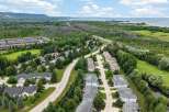 Discover this picturesque suburban neighborhood featuring a collection of modern townhouses nestled amidst lush greenery and mature trees.