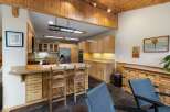This spacious kitchen boasts beautiful light wood cabinetry and granite countertops, offering ample storage and workspace.