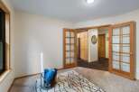 Discover a versatile space perfect for a home gym or office, featuring a large window for natural light and a cozy rug.