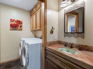 This laundry room and powder room combination offers both functionality and style.