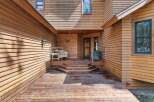 Step onto the expansive wooden deck and be welcomed by the charming entrance of this beautiful home.