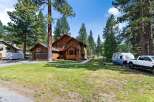 Discover this charming wooden home nestled among tall pine trees, offering a serene and private retreat.