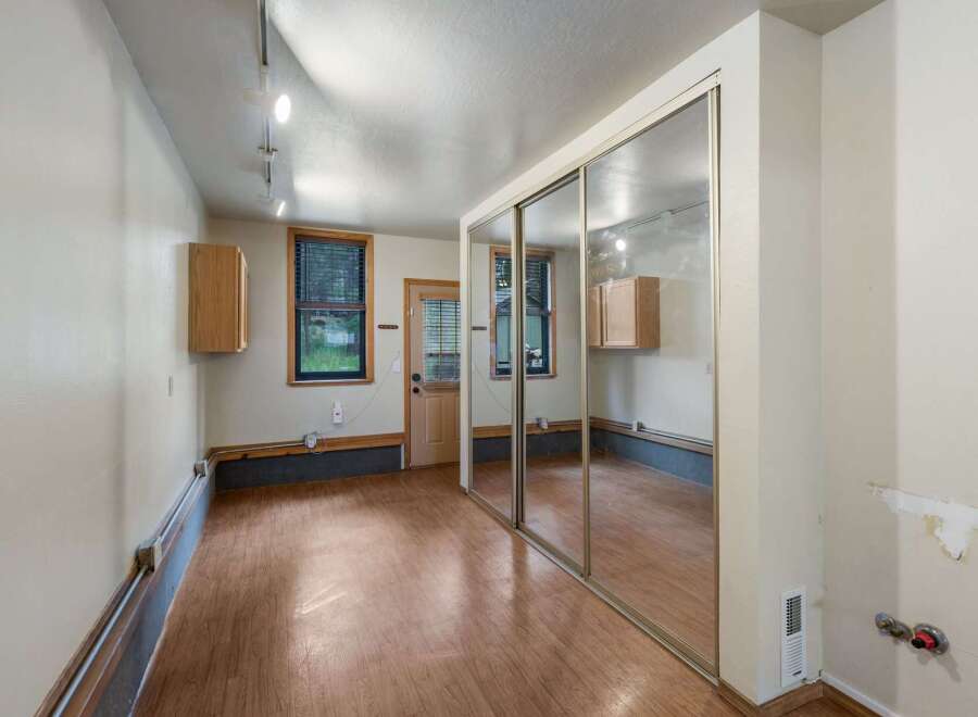 Discover this versatile space featuring a large mirrored closet, perfect for maximizing storage and creating an illusion of space.