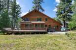 Experience the ultimate retreat in this stunning wooden home, nestled amongst tall pine trees.