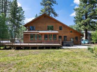 Experience the ultimate retreat in this stunning wooden home, nestled amongst tall pine trees.